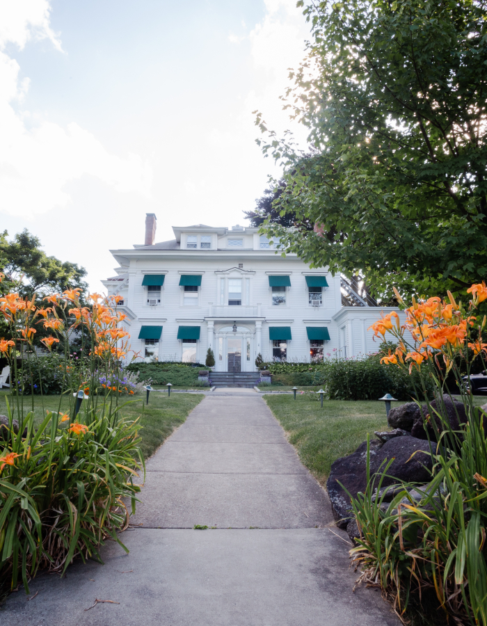The front of Stanton House Inn, in front of tiger lilies