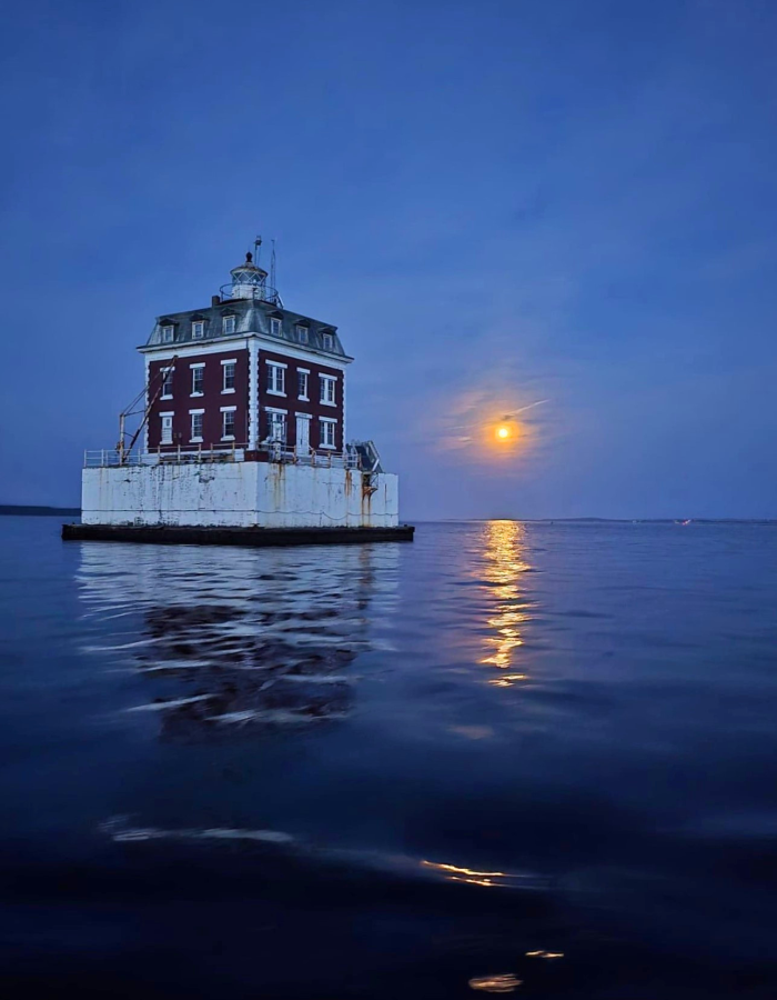 Full moon showing behind Ledge Light on the Thames River
