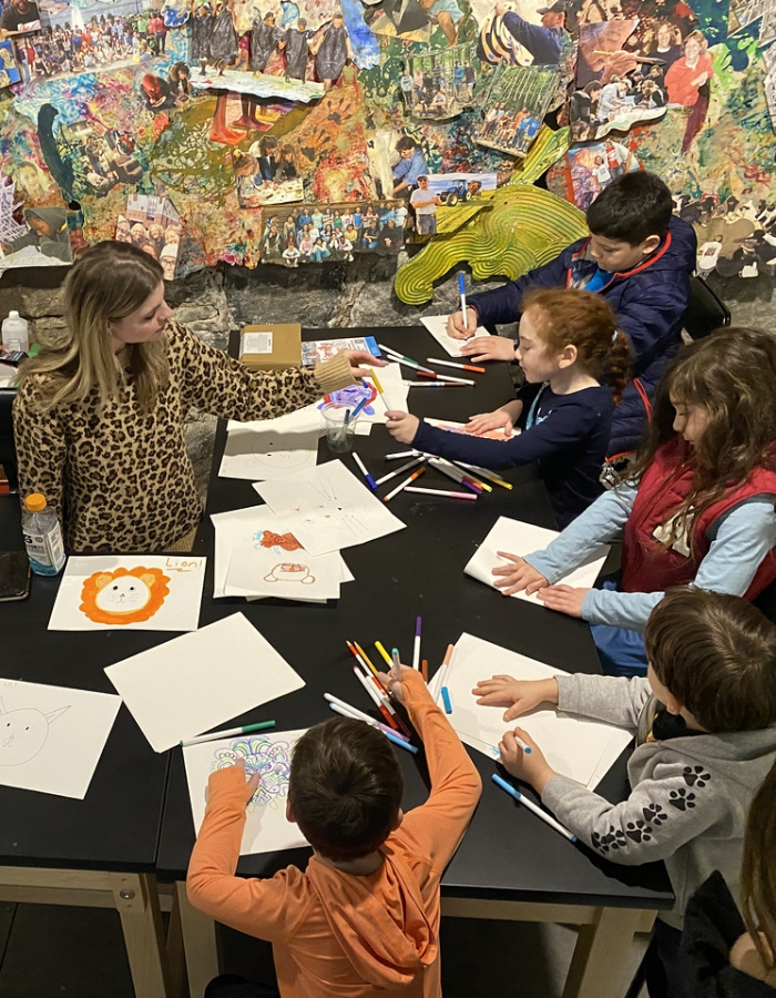 Art educator from the american mural project running an art activity from a previous family day.