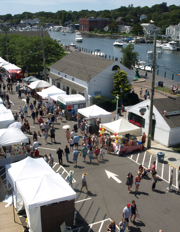 Guests enjoy the Mystic Outdoor Art Festival that stretches along the Mystic River
