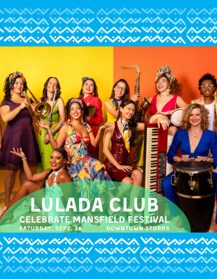 Eleven women in colorful outfits pose with their instruments