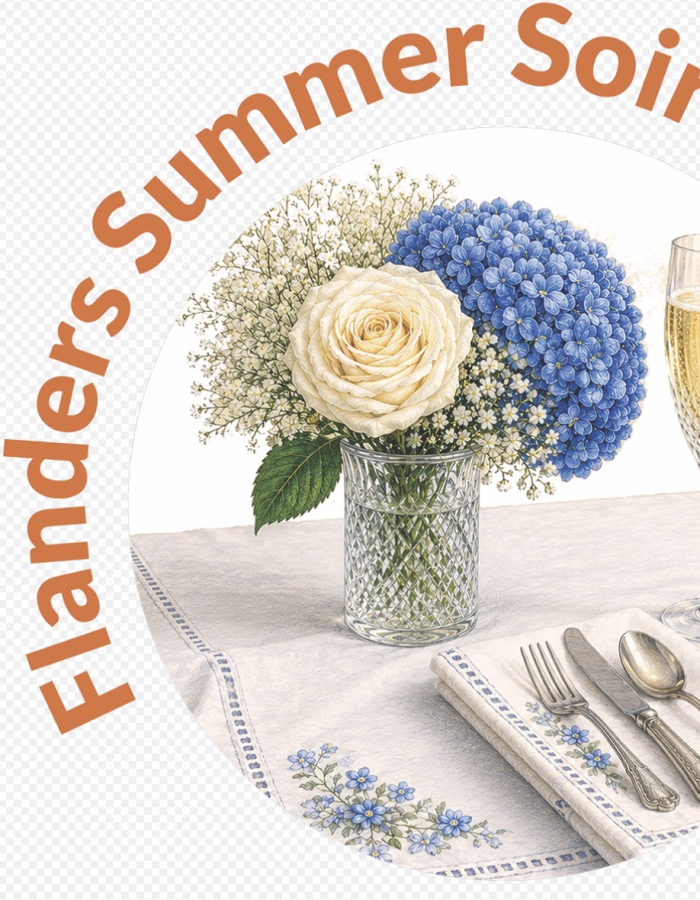 The image contains a vase with flowers, a champagne flute, and a fork, knife and spoon laying on top of a table.