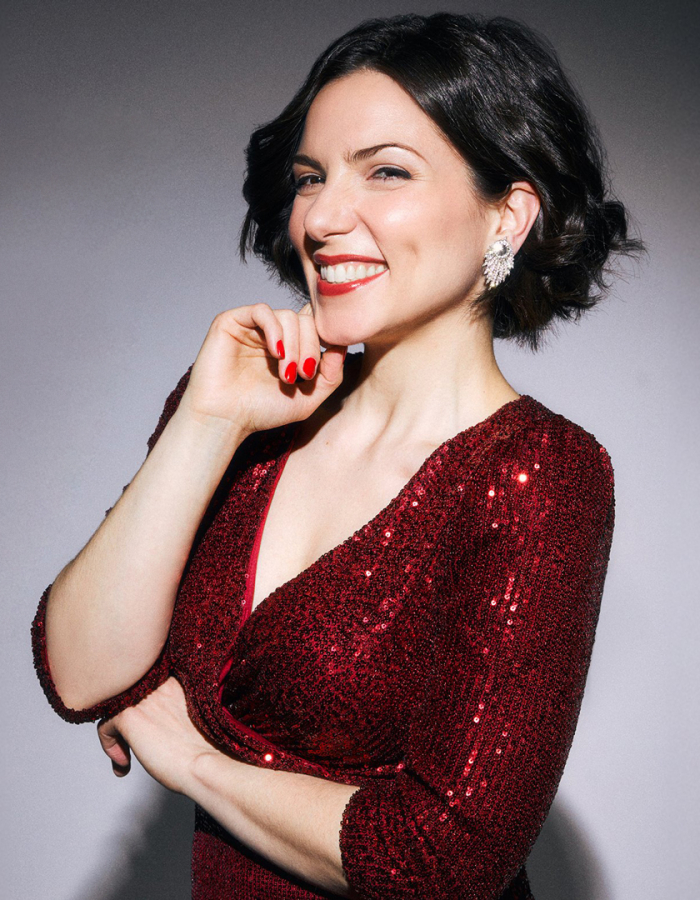 Woman smiling in a red sparkly dress 