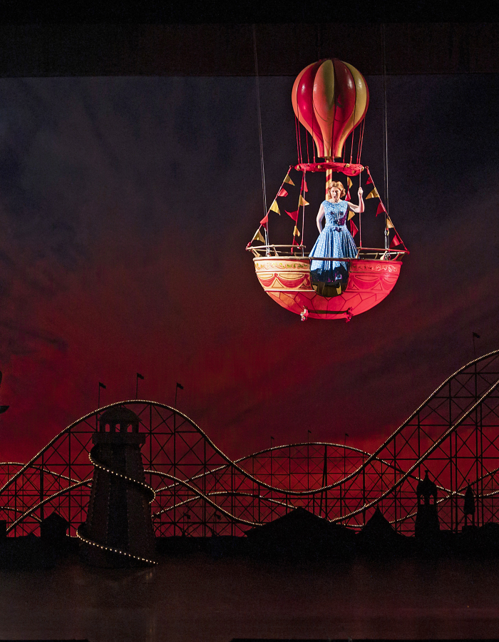 Actress floating on stage in a hot air balloon
