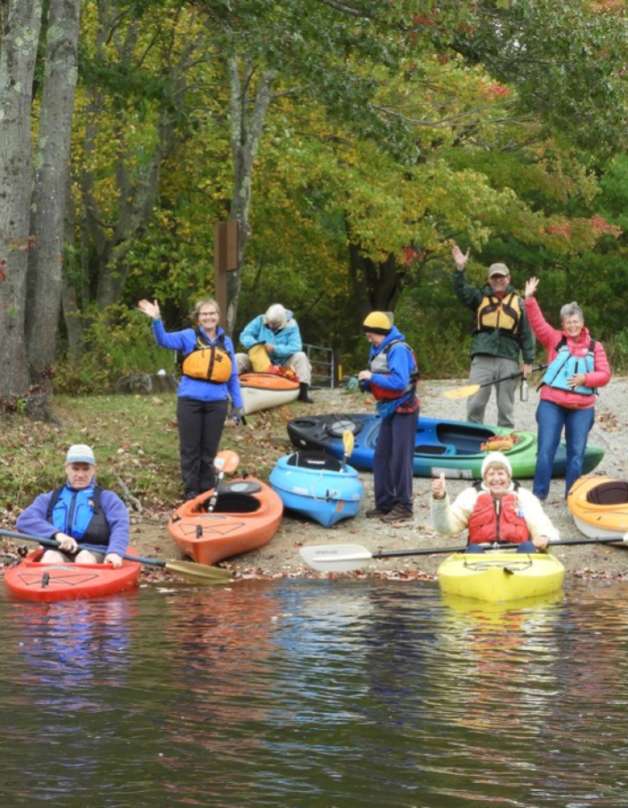 Group of kayakers waving