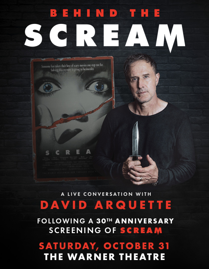 David Arquette standing in front of the Scream artwork holding a knife.