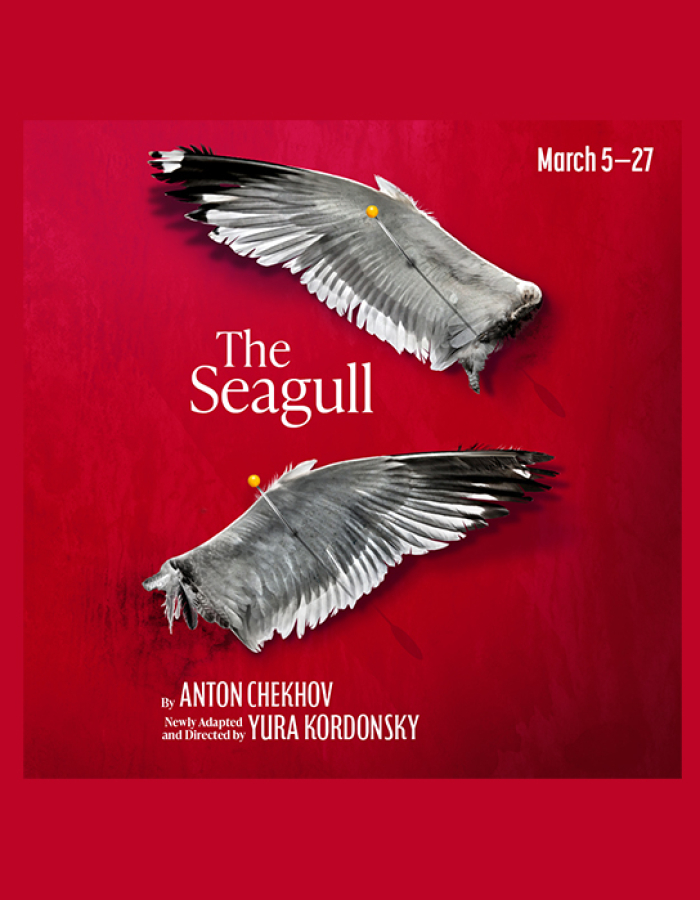 The Seagull red background, two severed gray-and-white seagull wings cross the image, pinned with a yellow-headed pin. 