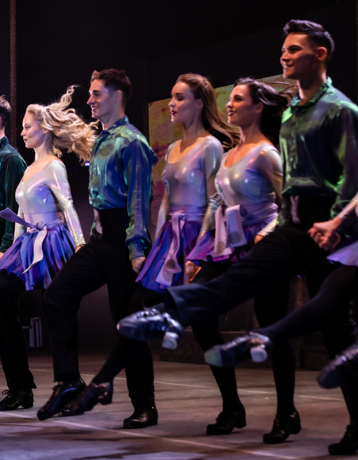 Line of Irish step dancers on stage.