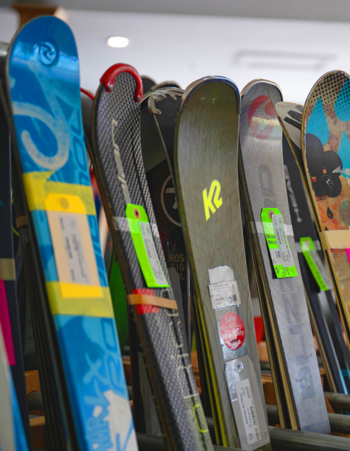 Ski racks holding a variety of used and new skis