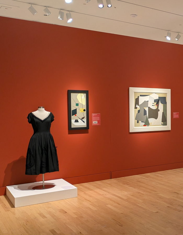 Gallery Exhibition with paintings, drawings, and clothing