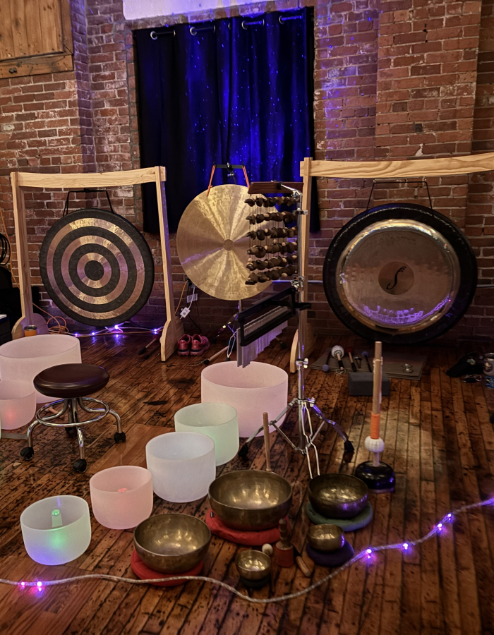 Gongs, colorful singing bowls, and lights setup for sound meditation