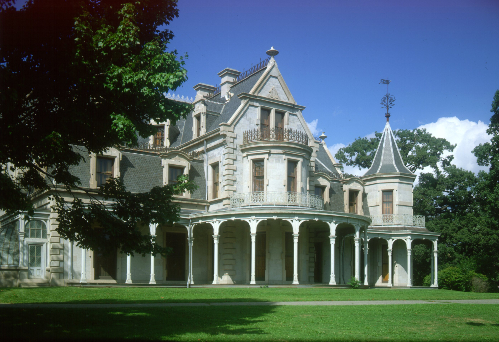 Victorian mansion with intricate balconies and wraparound porch