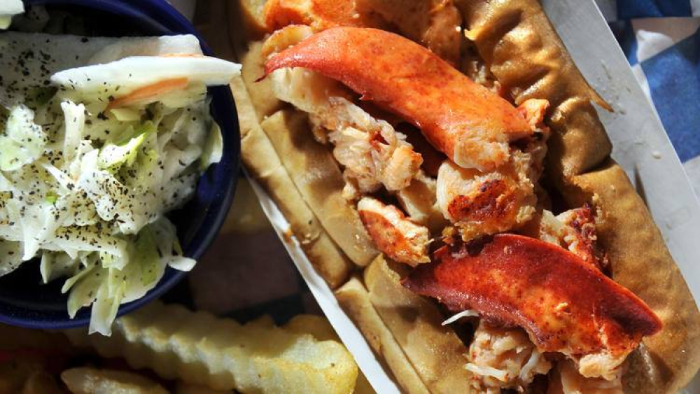 Lobster roll with coleslaw and crinkle-cut fries