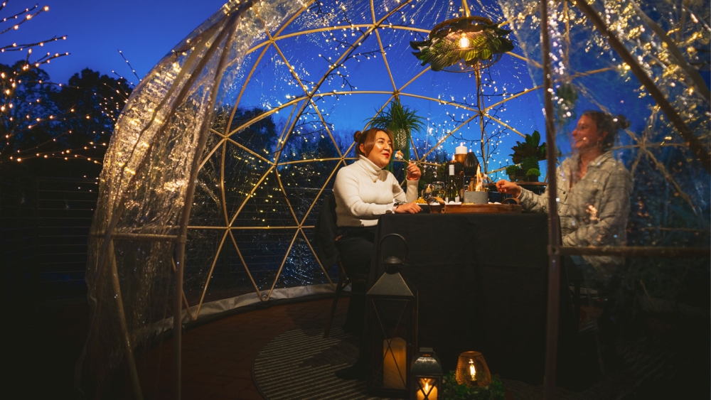 Outdoor dining in see-through igloo