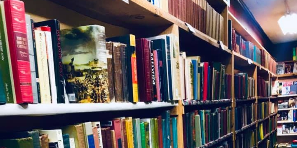 Long aisle of bookshelves filled with colorful books in a library