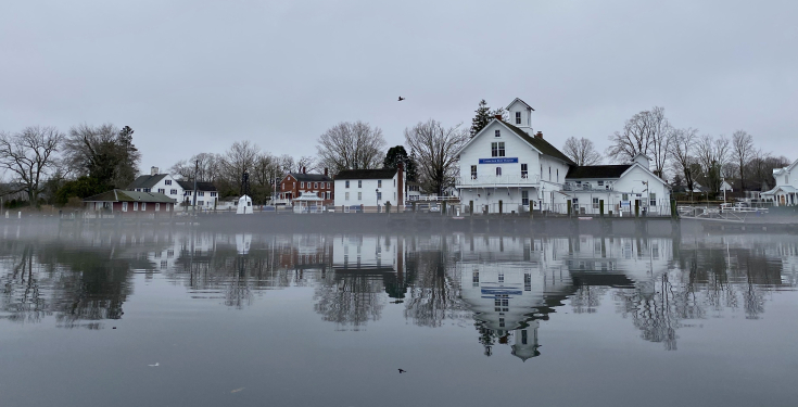 Connecticut River Museum and buildings reflected on calm river water