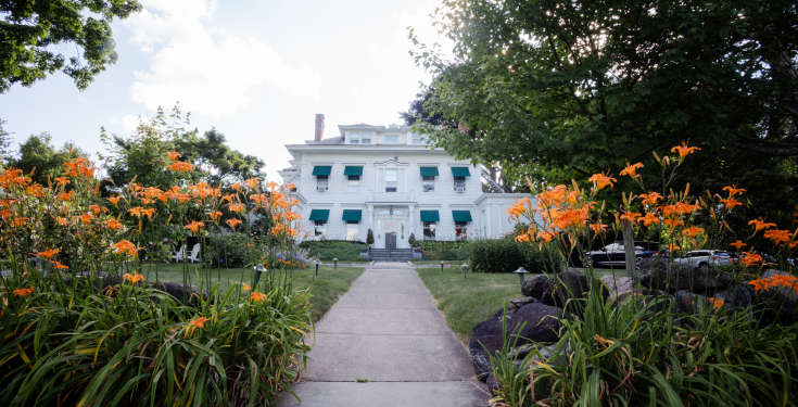 The front of Stanton House Inn, in front of tiger lilies